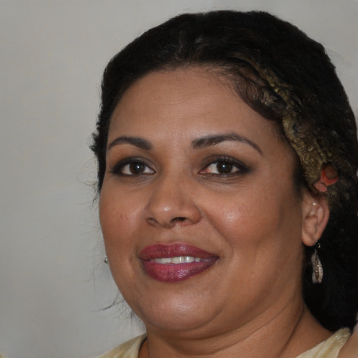 Joyful black adult female with medium  brown hair and brown eyes