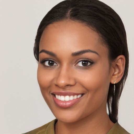 Joyful latino young-adult female with long  brown hair and brown eyes