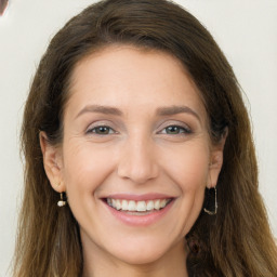 Joyful white young-adult female with long  brown hair and grey eyes