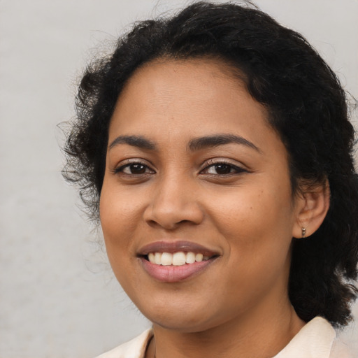 Joyful latino young-adult female with medium  black hair and brown eyes