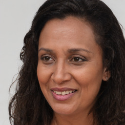 Joyful white adult female with long  brown hair and brown eyes