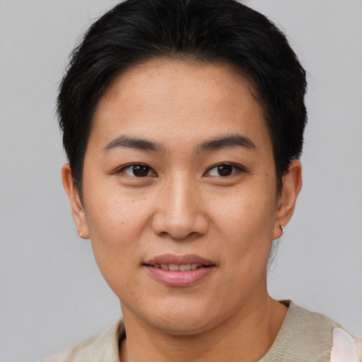 Joyful asian young-adult female with short  brown hair and brown eyes