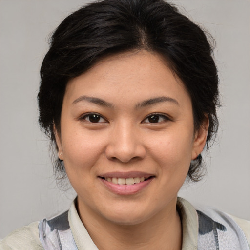 Joyful asian young-adult female with medium  brown hair and brown eyes