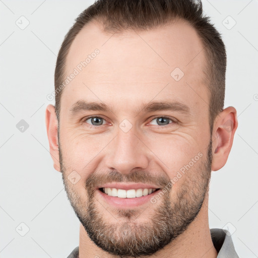 Joyful white young-adult male with short  brown hair and brown eyes