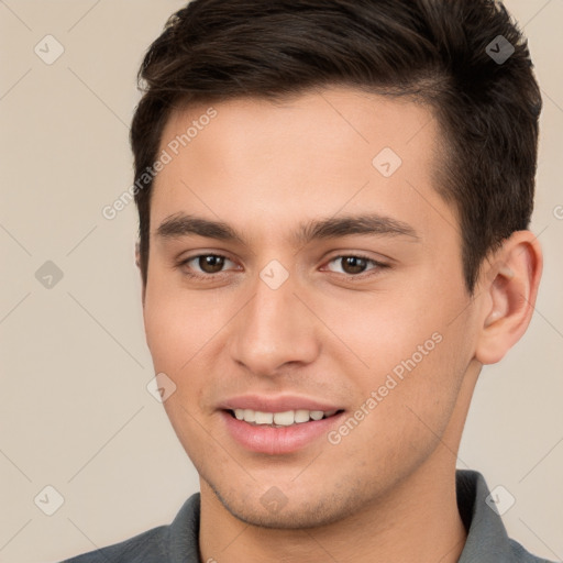 Joyful white young-adult male with short  brown hair and brown eyes