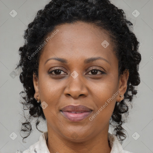 Joyful black adult female with medium  brown hair and brown eyes