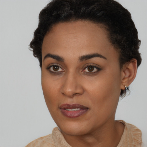 Joyful black young-adult female with short  brown hair and brown eyes