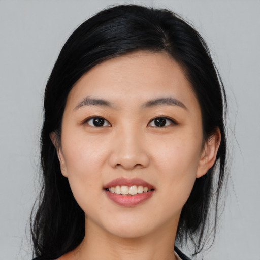 Joyful asian young-adult female with long  black hair and brown eyes
