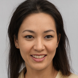 Joyful asian young-adult female with medium  brown hair and brown eyes