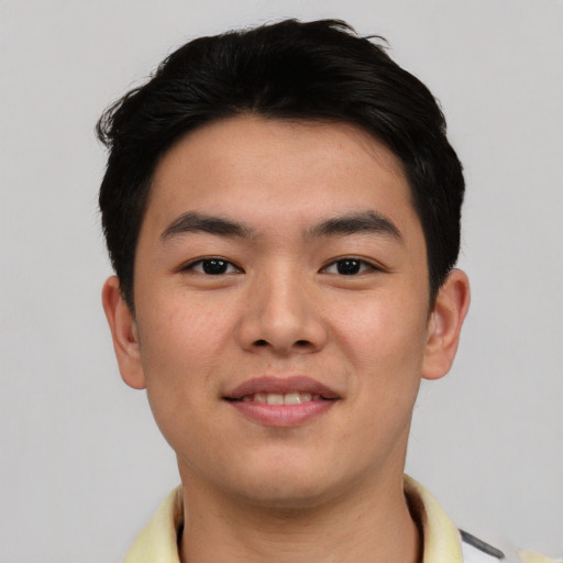 Joyful asian young-adult male with short  black hair and brown eyes