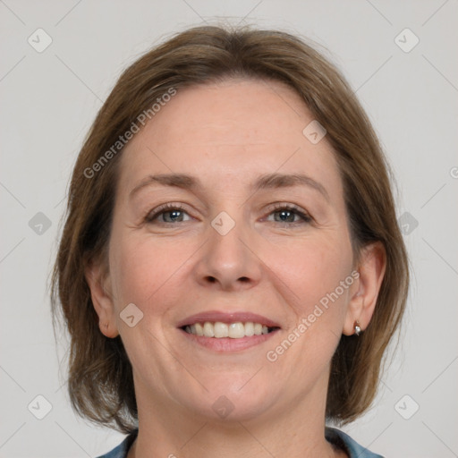 Joyful white adult female with medium  brown hair and grey eyes