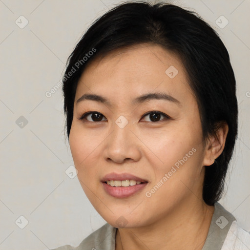 Joyful asian young-adult female with medium  black hair and brown eyes