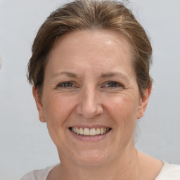 Joyful white adult female with short  brown hair and grey eyes