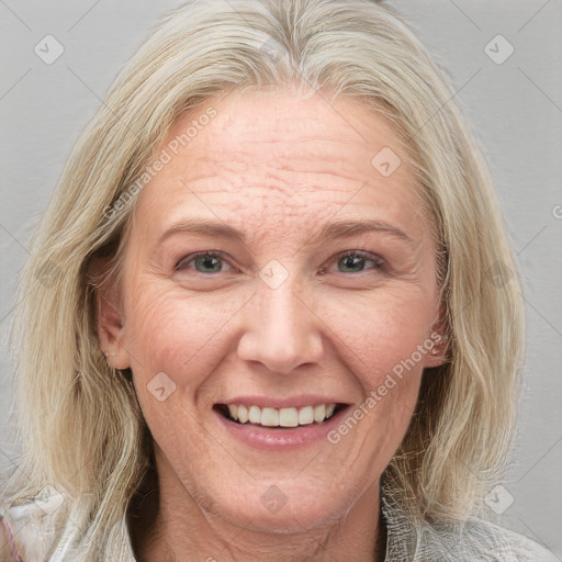 Joyful white adult female with medium  brown hair and blue eyes