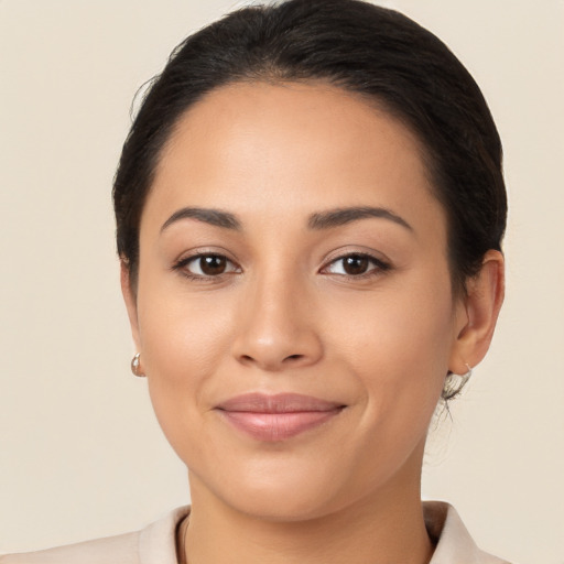 Joyful latino young-adult female with medium  brown hair and brown eyes