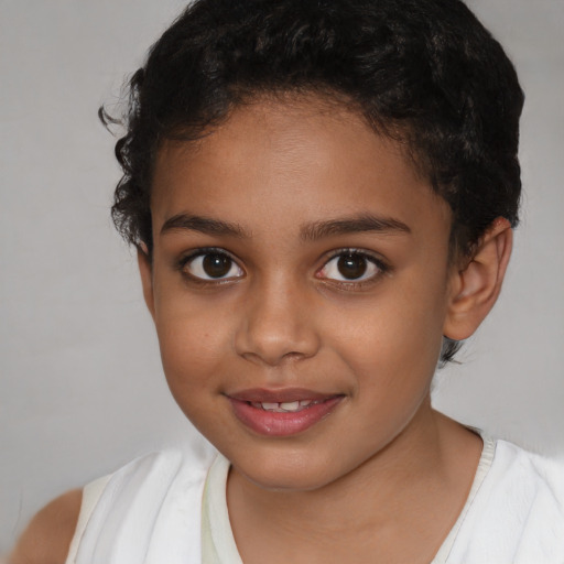 Joyful latino child female with short  brown hair and brown eyes