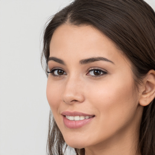 Joyful white young-adult female with long  brown hair and brown eyes