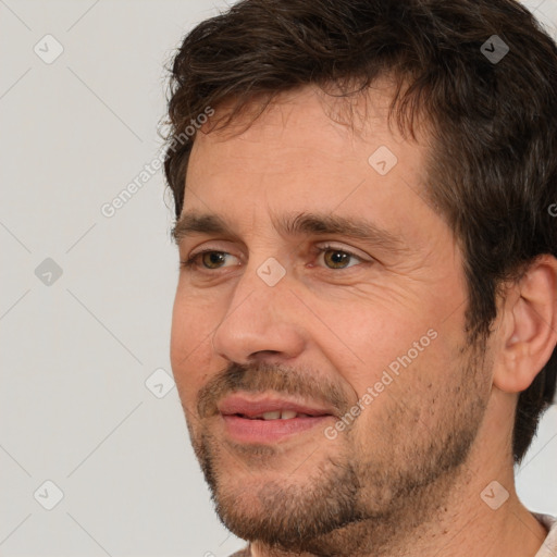 Joyful white adult male with short  brown hair and brown eyes