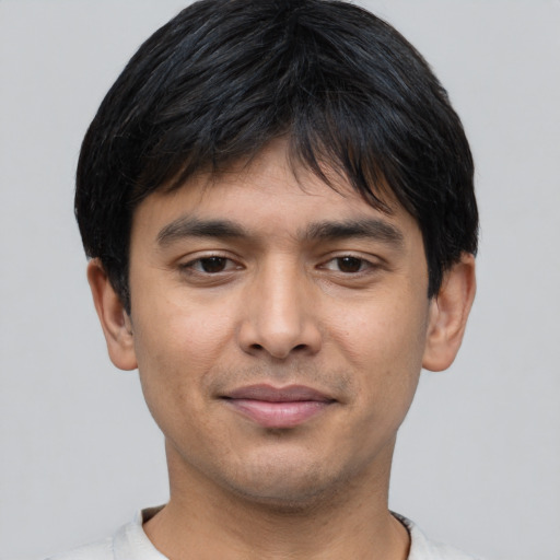 Joyful asian young-adult male with short  brown hair and brown eyes