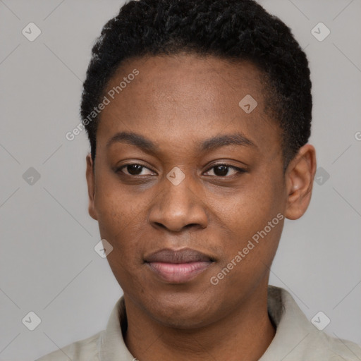 Joyful black young-adult female with short  black hair and brown eyes