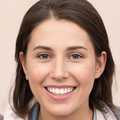 Joyful white young-adult female with medium  brown hair and brown eyes