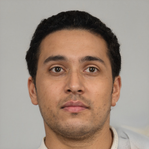 Neutral latino young-adult male with short  black hair and brown eyes