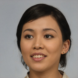 Joyful asian young-adult female with medium  black hair and brown eyes