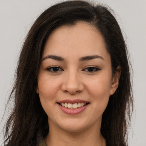 Joyful latino young-adult female with long  brown hair and brown eyes