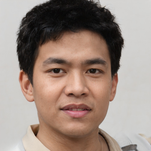 Joyful asian young-adult male with short  brown hair and brown eyes