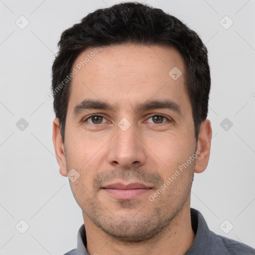 Joyful white young-adult male with short  black hair and brown eyes