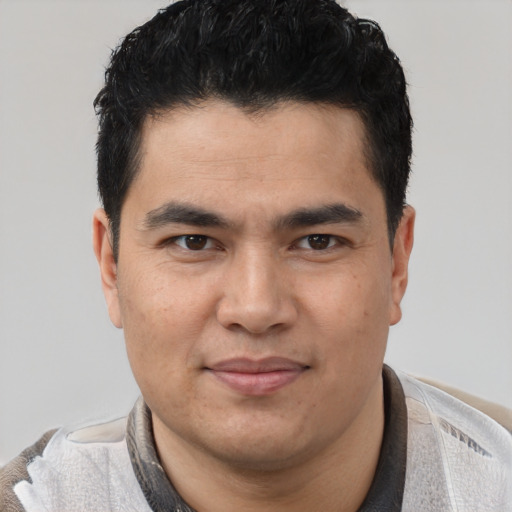 Joyful latino young-adult male with short  black hair and brown eyes