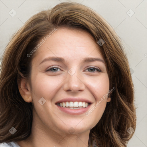 Joyful white young-adult female with long  brown hair and blue eyes