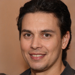 Joyful white adult male with medium  brown hair and brown eyes