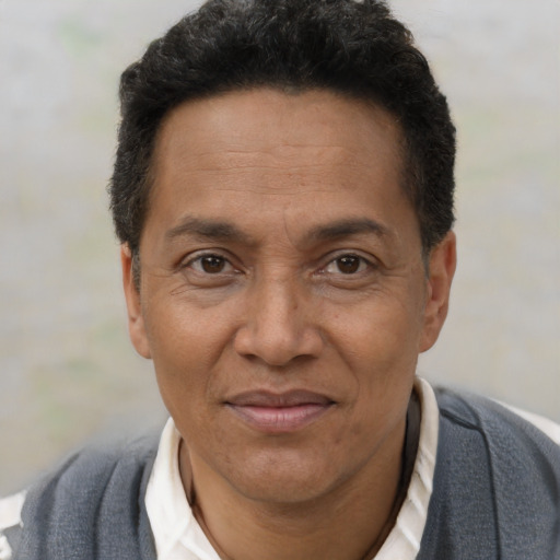 Joyful black adult male with short  brown hair and brown eyes