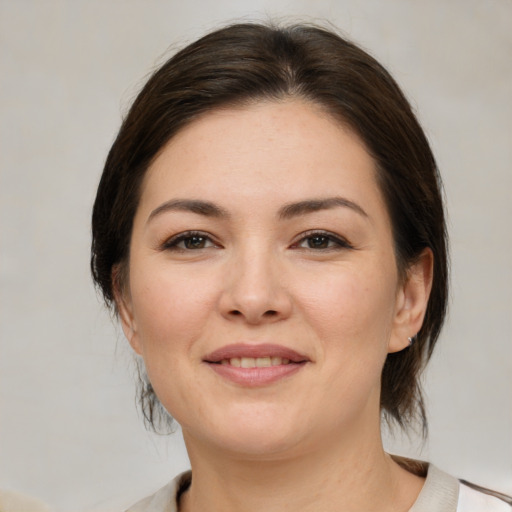 Joyful white young-adult female with medium  brown hair and brown eyes
