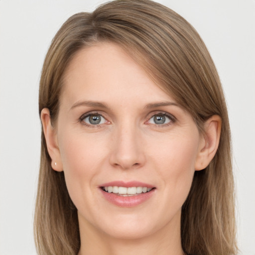 Joyful white young-adult female with long  brown hair and grey eyes