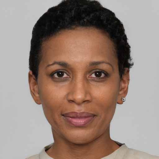 Joyful black adult female with short  black hair and brown eyes