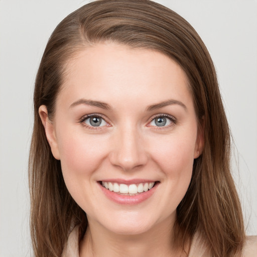 Joyful white young-adult female with long  brown hair and grey eyes