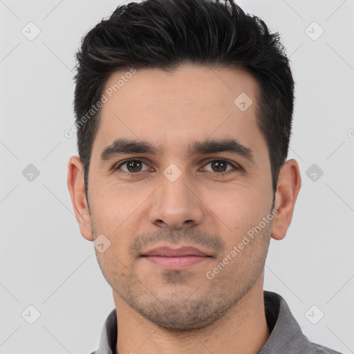 Joyful white young-adult male with short  black hair and brown eyes