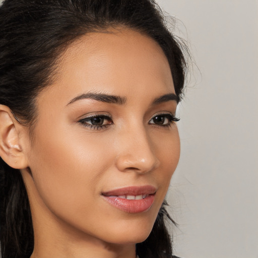 Joyful latino young-adult female with long  brown hair and brown eyes