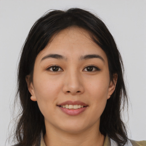 Joyful asian young-adult female with long  brown hair and brown eyes