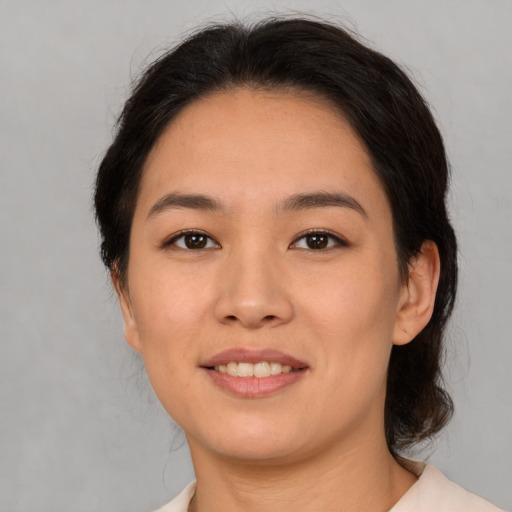 Joyful asian young-adult female with medium  brown hair and brown eyes