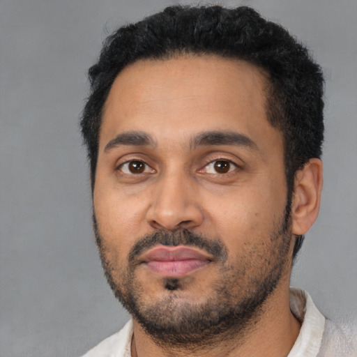 Neutral latino young-adult male with short  black hair and brown eyes