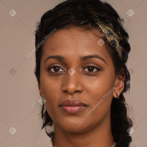 Joyful black young-adult female with long  brown hair and brown eyes