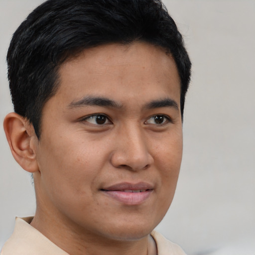 Joyful asian young-adult male with short  brown hair and brown eyes