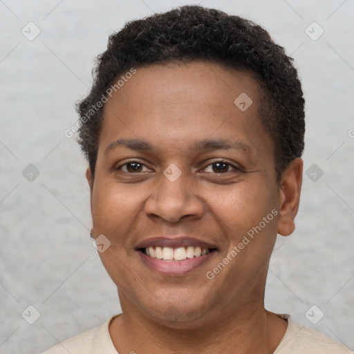 Joyful black young-adult male with short  brown hair and brown eyes