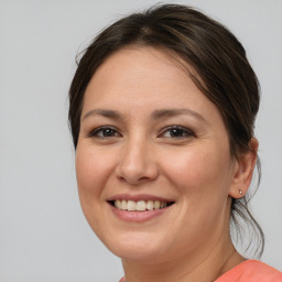 Joyful white young-adult female with medium  brown hair and brown eyes