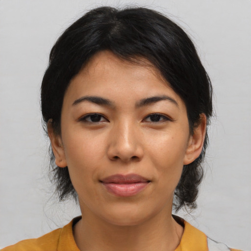 Joyful asian young-adult female with medium  black hair and brown eyes
