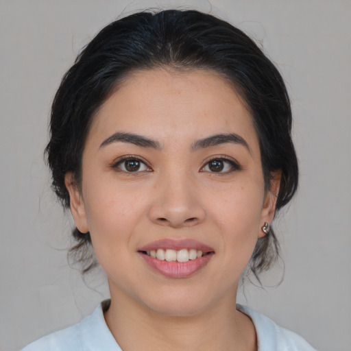 Joyful asian young-adult female with medium  brown hair and brown eyes