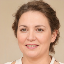 Joyful white adult female with medium  brown hair and brown eyes